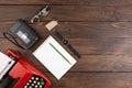 Writer or journalist workplace - vintage red typewriter, cassette recorder and notepad on the wooden desk Royalty Free Stock Photo