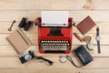 Writer or journalist workplace vintage red typewriter, photo camera, cassette recorder on the wooden desk Royalty Free Stock Photo