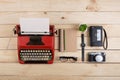 Writer or journalist workplace vintage red typewriter, photo camera, cassette recorder on the wooden desk Royalty Free Stock Photo