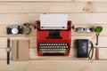 Writer or journalist workplace vintage red typewriter, photo camera, cassette recorder on the wooden desk Royalty Free Stock Photo