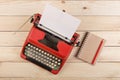 Writer or journalist workplace - vintage red typewriter on the wooden desk Royalty Free Stock Photo