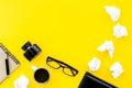 Writer office desk with notebook, ink, pen and glasses yellow background top view space for text Royalty Free Stock Photo