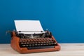 writer's workplace - red typewriter on blue blackboard background Royalty Free Stock Photo