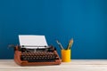writer's workplace - red typewriter and stationery on blue blackboard background Royalty Free Stock Photo