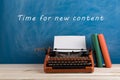 writer's workplace - red typewriter and stationery on blue blackboard background with text "Time for a new content Royalty Free Stock Photo