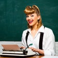 Writer or secretary. Vintage. Beautiful girl with a typewriter. Retro style. Clever beauty blonde. Journalism. Royalty Free Stock Photo