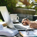 Writer taking notes from laptop outdoors with coffee Royalty Free Stock Photo