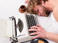 Writer used old fashioned typewriter. Author tousled hair fall asleep while write book. Workaholic fall asleep. Man with