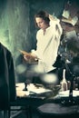 Writer at work. Handsome young writer standing near the table and making up something in his mind Royalty Free Stock Photo