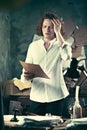 Writer at work. Handsome young writer standing near the table and making up something in his mind Royalty Free Stock Photo