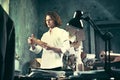 Writer at work. Handsome young writer standing near the table and making up something in his mind Royalty Free Stock Photo