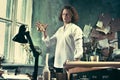 Writer at work. Handsome young writer standing near the table and making up something in his mind Royalty Free Stock Photo