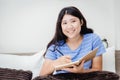 Girl teen with notebook holding pen looking camera and smile in bedroom Royalty Free Stock Photo