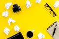 Writer workplace with tools for work on yellow table background top view mockup