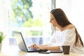 Writer writing on a laptop in a warm place