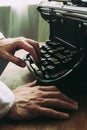 A writer writing a novel, using old vintage typewriter Royalty Free Stock Photo