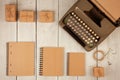 vintage typewriter, notepads, present boxes on the white wooden background Royalty Free Stock Photo