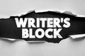 Writers Block text on ripped paper background. Concept for creative struggle, difficulty writing, brainstorming problems, idea Royalty Free Stock Photo