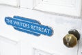 Writers retreat door sign at entrance to quiet peace room for mindfulness and thinking writing zone