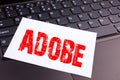 Writing ADOBE text made in the office close-up on laptop computer keyboard. Business concept for Software Company Name Workshop on