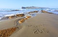 Writing be happy 2019 on the sand with the rays of the sun. Marvelous sea with waves, footprints on the coast. Rest Crete island.