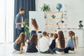 Writing on the board. Group of children students in class at school with teacher Royalty Free Stock Photo
