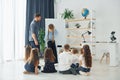 Writing on the board. Group of children students in class at school with teacher Royalty Free Stock Photo