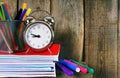 Writing-books, an alarm clock and school tools. Royalty Free Stock Photo