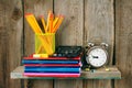 Writing-books, an alarm clock and school tools . Royalty Free Stock Photo