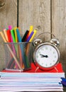 Writing-books, an alarm clock and school tools. Royalty Free Stock Photo