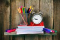 Writing-books, an alarm clock and school tools. Royalty Free Stock Photo