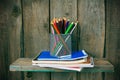 Writing-books and school tools on a wooden shelf. Royalty Free Stock Photo