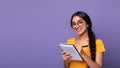 Indian woman holding pen writing in notebook at studio Royalty Free Stock Photo