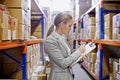 Writing, clipboard or business woman at a warehouse for logistics, planning or inventory. Admin, factory or employee Royalty Free Stock Photo