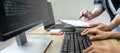Writing codes and typing data code technology, Programmer team working on web site project in a software development on desktop Royalty Free Stock Photo