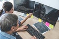 Writing codes and typing data code technology, Two professional programmer cooperating working on web site project in a software Royalty Free Stock Photo