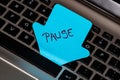 Writing on colorful sticky note Pause. Text with Pause on paper. Sticky note, post it on keyboard