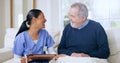 Writing, consulting and nurse with senior man on sofa for medical care, support and service. Healthcare, retirement home Royalty Free Stock Photo