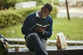 Writing, creative thinking and planning businessman sitting on park bench working on corporate strategy. Employee man Royalty Free Stock Photo