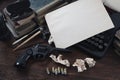 Writing a crime fiction story - old retro vintage typewriter and revolver gun with ammunitions, books, blank paper, old ink pen Royalty Free Stock Photo