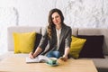 Writing dairy on notebook in coffee shop, concept as memory of life. woman with mobile phone and pen on Wooden table Royalty Free Stock Photo