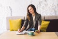 Writing dairy on notebook in coffee shop, concept as memory of life. woman with mobile phone and pen on Wooden table Royalty Free Stock Photo