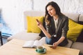 Writing dairy on notebook in coffee shop, concept as memory of life. woman with mobile phone and pen on Wooden table Royalty Free Stock Photo