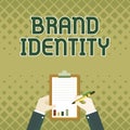 Hand writing sign Brand Identity. Concept meaning visible elements of a brand that identify and distinguish Business