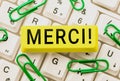 Writing displaying text Merci. Word for thank you in French what is said when someone helps you in France