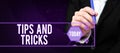 Writing displaying text Tips And Tricks. Business concept helpful advices that makes certain action easier to do Royalty Free Stock Photo