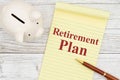 Writing down your retirement plan with a piggy bank, notepad and pen Royalty Free Stock Photo