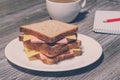 Writing essay business education food snack eating concept. Business breakfast. Tasty ham and cheese sandwich with cup of coffee, Royalty Free Stock Photo