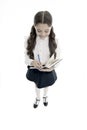 Writing essay. School girl excellent pupil prepared essay or school project. Schoolgirl wear school uniform. Knowledge Royalty Free Stock Photo