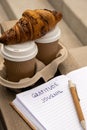 Writing Gratitude Journal on wooden bench. Coffee and croissants morning routine. Today I am grateful for. Self